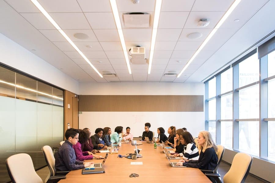 A boardroom meeting around a long table