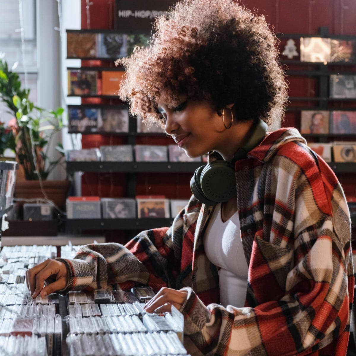 A woman flicking through records in a record shop